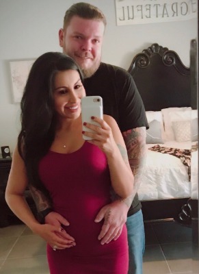 Corey Harrison placing his hands over Korina Harrison's baby bump.